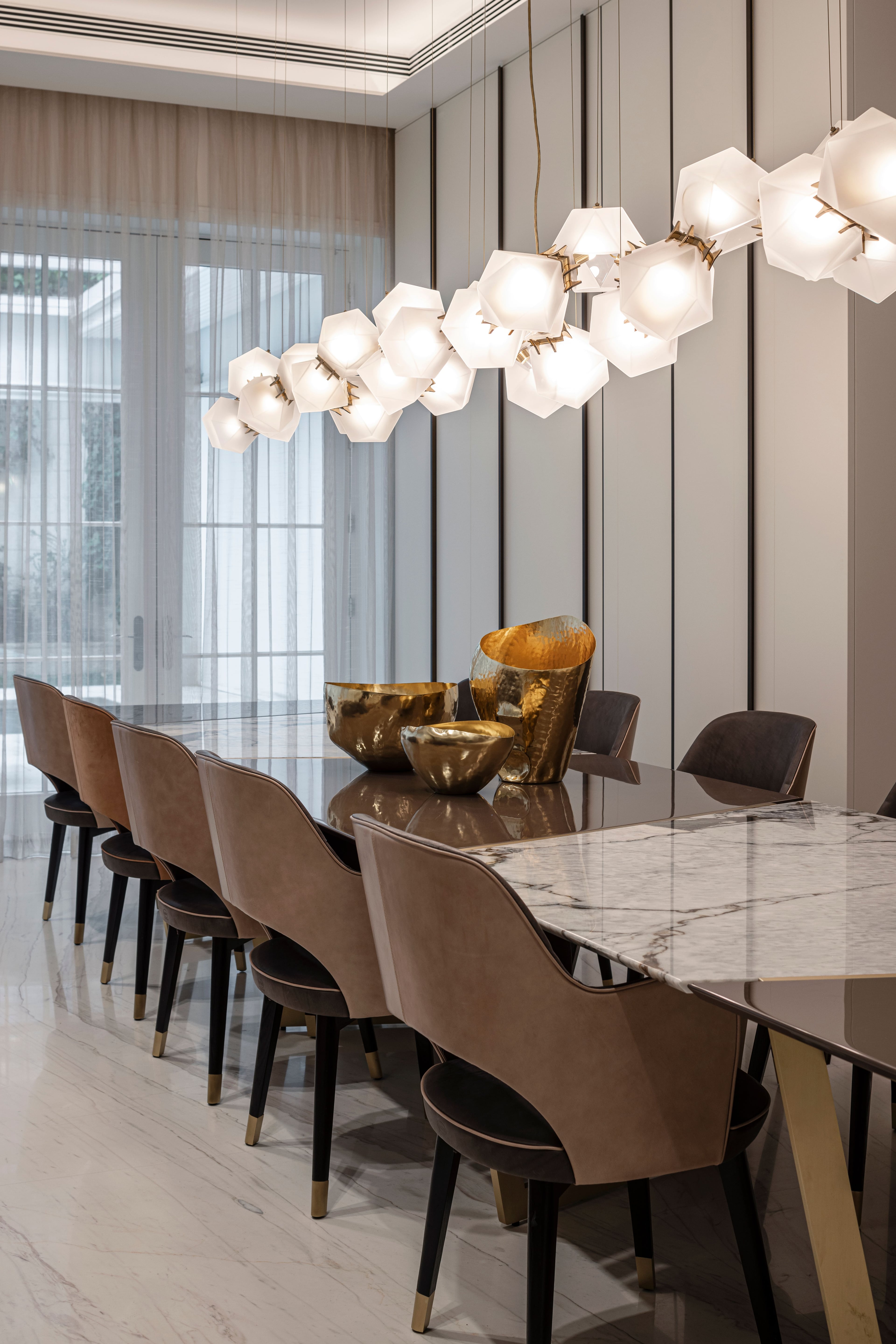 A living room and dining room with dark and light wood cladding tones. 